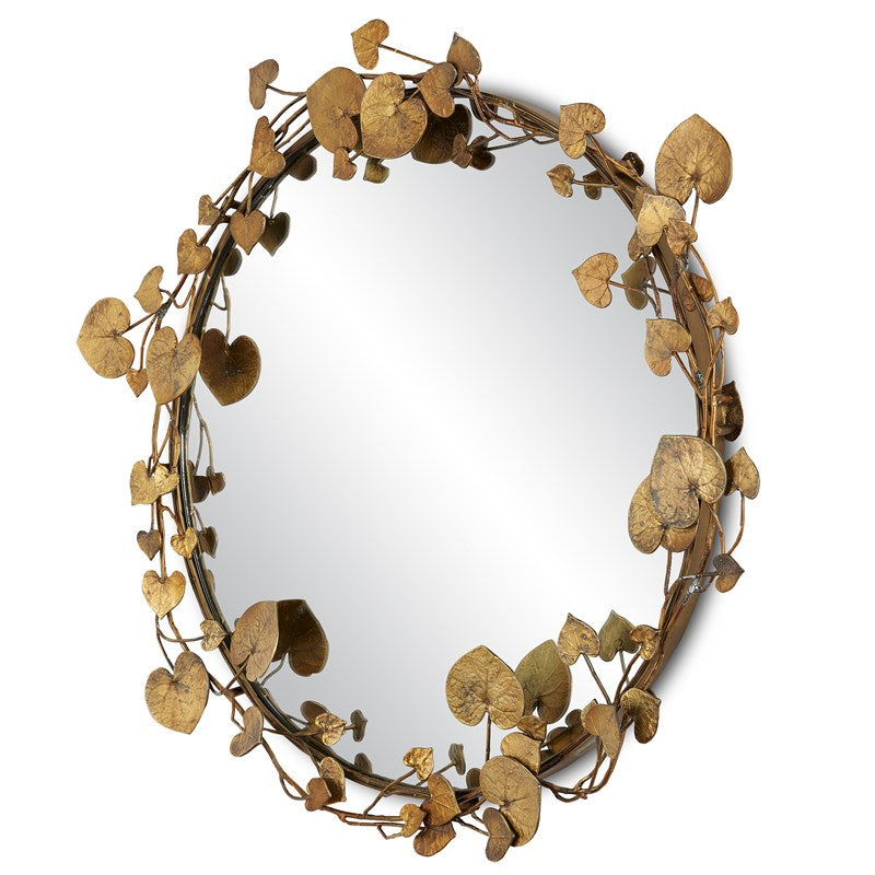 Side view of the mirror encased by the antique brass finish leaves.